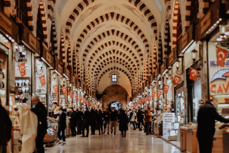 Explore the vibrant hustle of Istanbul's Grand Bazaar with shops and crowds.