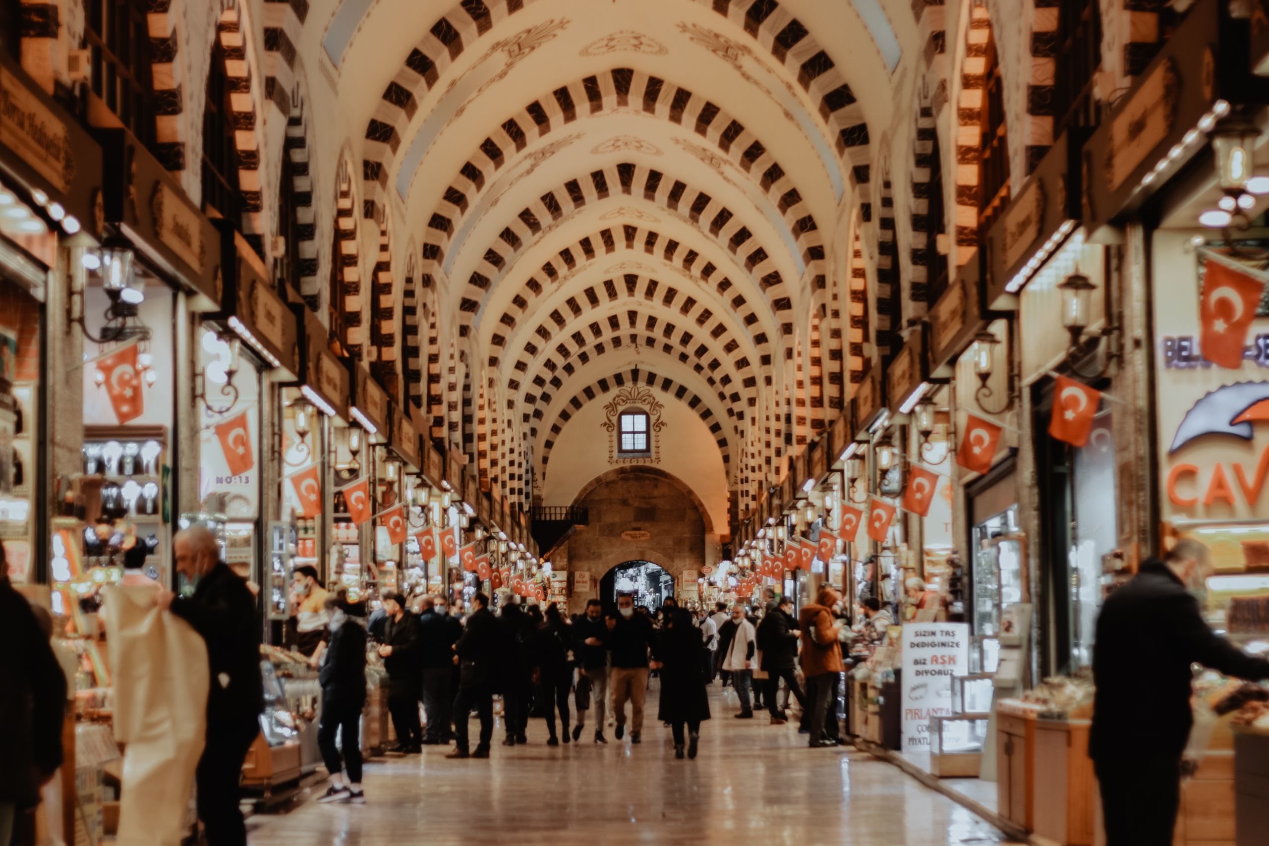 Explore the vibrant hustle of Istanbul's Grand Bazaar with shops and crowds.